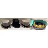 Three small top hats, and an unusual metal hat box, with feathers inside
