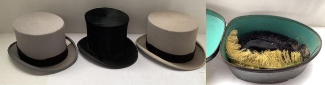 Three small top hats, and an unusual metal hat box, with feathers inside