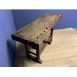 C18th rustic country made carpenter's work bench with wooden screw vice and metal pegs, approx 162