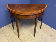 Regency satinwood crossbanded mahogany half round fold over card/tea table on inlaid tapered legs to