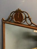 Good quality mahogany framed oblong wall mirror with scrolling carved finial and ears, the oblong