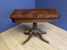 Regency figured mahogany pedestal fold over oblong card/tea table on reeded quadruped swept legs