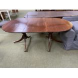 Reproduction mahogany D end pedestal dining table with one leaf on pedestals to brass casters.