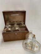 a C19th mahogany fitted box, the lid rising to reveal 6 gilded glass bottles with stoppers, 2