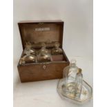 a C19th mahogany fitted box, the lid rising to reveal 6 gilded glass bottles with stoppers, 2