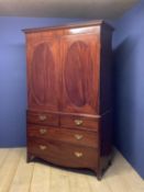 Good early C19th figured mahogany linen press, the 2 doors with inlaid & fielded oval panels (