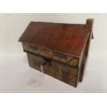 Wooden tea caddy in the form of an Elizabethan cottage. 21cm L x 19cm H. Condition: generally