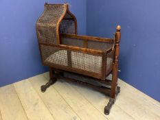 Victorian mahogany framed bergère crib swinging on a stand. 124cm H, the crib 90cm L. Condition: