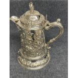 Victorian silver flagon profusely chased with repoussé foliage & scrolls, a crest to the