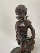 Bronze study of a playing cupid, signature indistinguishable, stamped 27cm H including base.