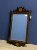 Small early C18th fret cut mahogany bevelled wall mirror with gilded inset frame below a shell