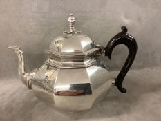 An octagonal silver teapot in early C18th style, the circular body with a cast swan neck spout,