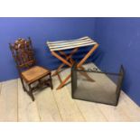 Folding luggage stand, carved oak child's chair and a folding fire-guard Condition: Split/damage