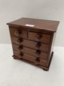 Mahogany chest of 3 long below 2 short drawers, on bun feet, in the style of an apprentices