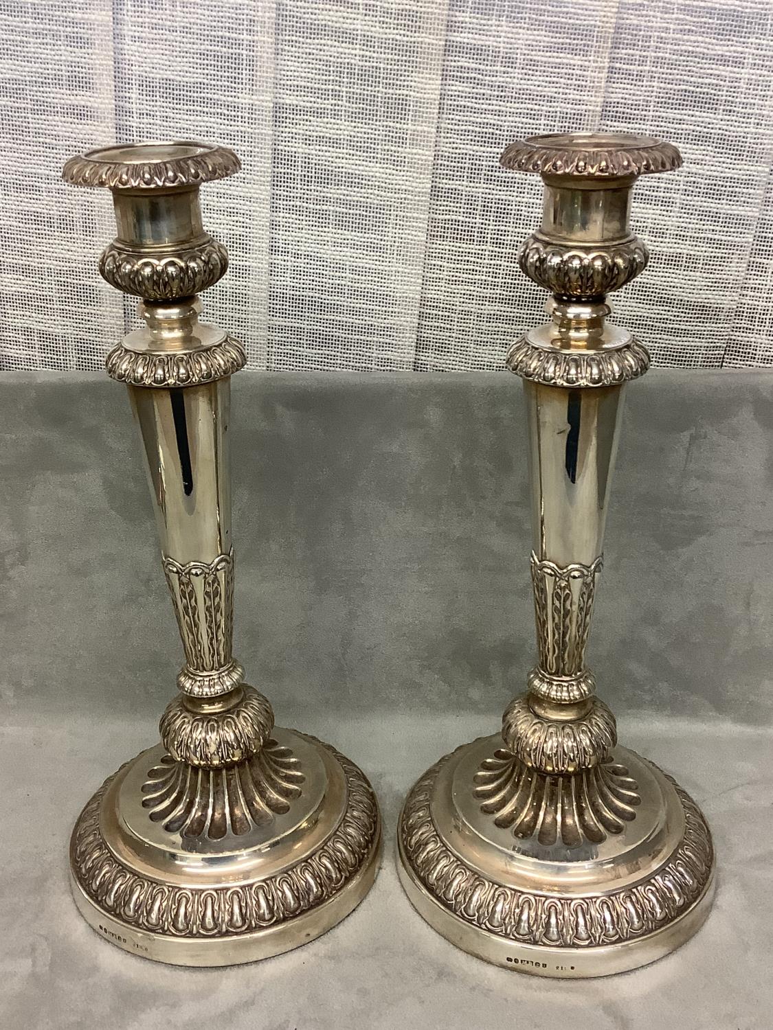 Pair of Georgian Hallmarked Silver (weighted) circular embossed candle sticks. 35cm H (1815),