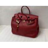 Red leather ladies handbag made in Italy, in the style of a Hermes Birkin bag. Condition: Some