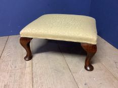 Small footstool upholstered in yellow fabric