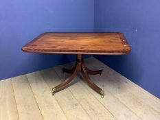 Mahogany tilt top rectangular breakfast table on quadruped base with sept feet to brass castors