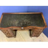 Small serpentine front mahogany writing desk (1 piece) of 9 bow front drawers below a tooled leather