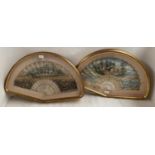A pair of glass cased fans, each mounted fan decorated with classical scenes