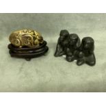 Chinese bronze dog form scroll weight, wood stand; together with three bronze monkey form scroll