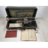 A cased trumpet, Boosey & Co, see images for details and condition, and a book "Trumpet and Bugle