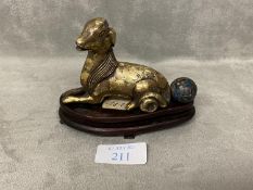 Chinese bronze scroll weight in the form of a dog, with a cloisonne bead, wood stand.