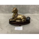 Chinese bronze scroll weight in the form of a dog, with a cloisonne bead, wood stand.