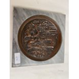 Bronze dish depicting classical figures set within a grey square base, in the style of The Grand
