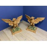 A pair of carved wood painted spread winged eagles, formerly used as a table base 73 cm high x 88 cm
