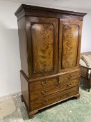 A good C19th flame mahogany linen press, with two doors above 2 short over 2 long drawers