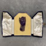 Carved amethyst model of a parrot with intagio stamp to base, in a James Ogdon and Sons fitted box,