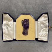 Carved amethyst model of a parrot with intagio stamp to base, in a James Ogdon and Sons fitted box,