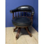 A good green leather and mahogany framed swivel desk chair