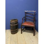 A brass bound oak umbrella stand, and a mahogany armchair with red leather seat