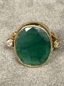 Unmarked yellow metal emerald and diamond ladies dress ring, central oval free cut emerald , 14 mm