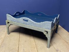 A decorative low tray on stand, painted in blue and decorated with butterflies