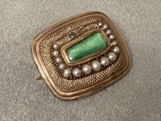 A yellow metal and seed pearl mourning brooch with central quartz window