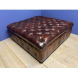 A good quality large square buttoned back brown leather stool, approx. 130cm square, 49cm high