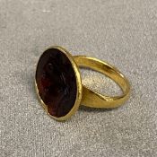 Unmarked yellow metal seal ring, with carved gem set intaglio of a classical bust, 6.1 g size L