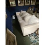 A large cream/grey upholstered low sofa