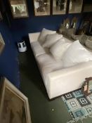 A large cream/grey upholstered low sofa
