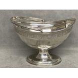 George III Hallmarked Silver swing handle basket with engraved borders & crested cartouches on a
