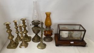 An oak framed and glass cased barograph, brass candlesticks, oil lamp and crucifix