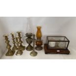 An oak framed and glass cased barograph, brass candlesticks, oil lamp and crucifix