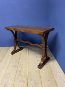 A narrow mahogany hall side table, with double splayed legs united by central stretcher