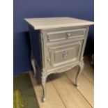 A bedside table, decorated in a metallic grey style paint and a white top