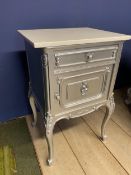 A bedside table, decorated in a metallic grey style paint and a white top