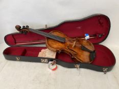 A violin labelled Maggini. With a silver mounted bow in case. The two piece back of birds eye maple,