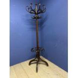 A wooden column hat/coat stand in the bentwood style